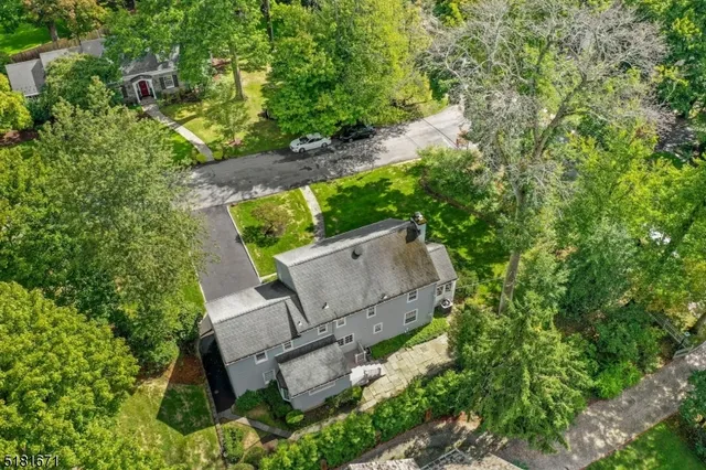 an aerial view of a house with a yard and outdoor seating
