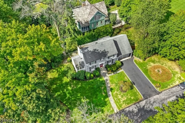 an aerial view of house with yard and mountain view in back