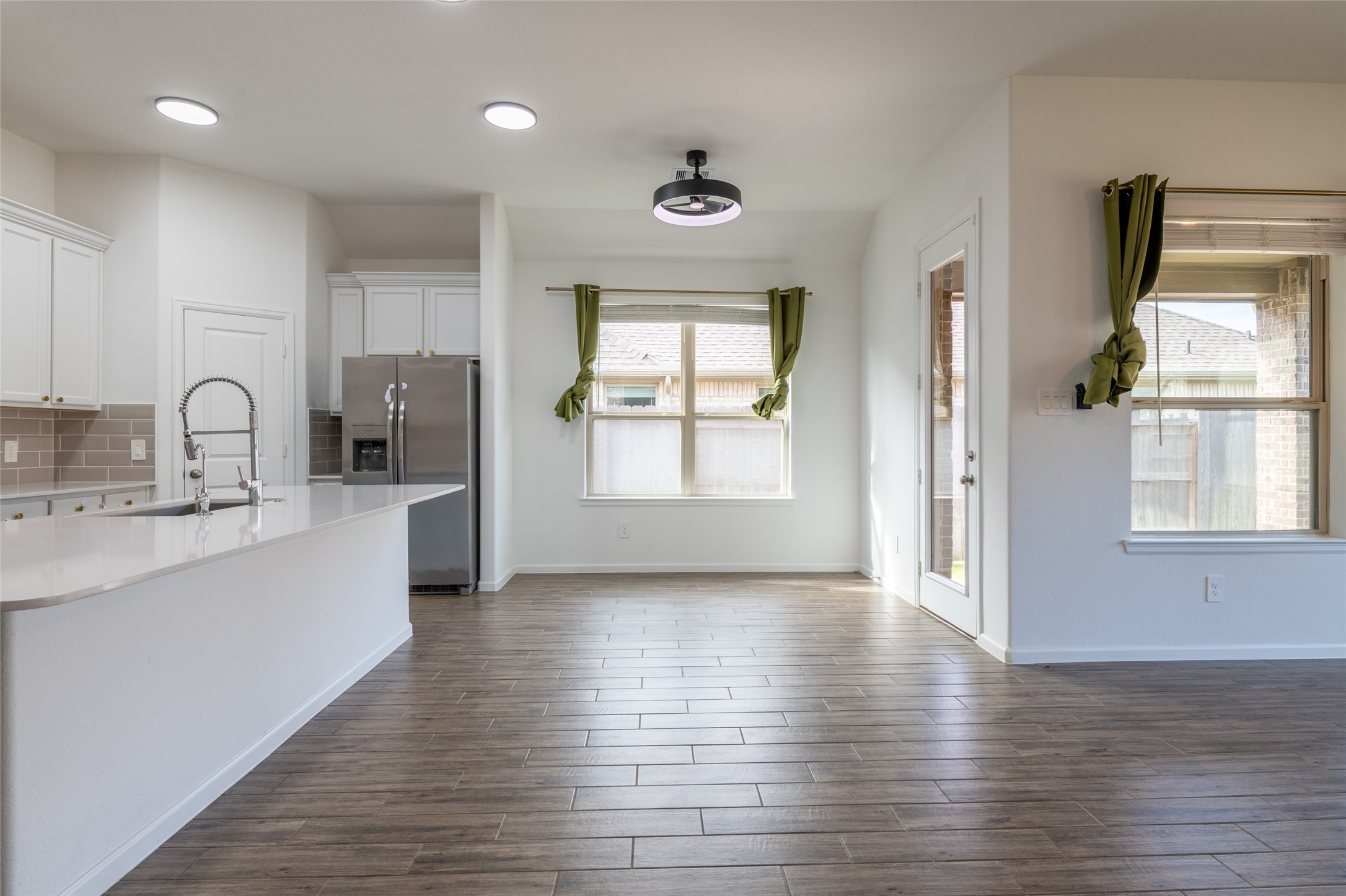 15023 Mulberry Hallow Street Conroe, TX 77302 - Photo 11 of 41 a kitchen with granite countertop a stove a sink and a window