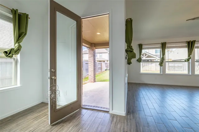 a view of an entryway with wooden floor and door