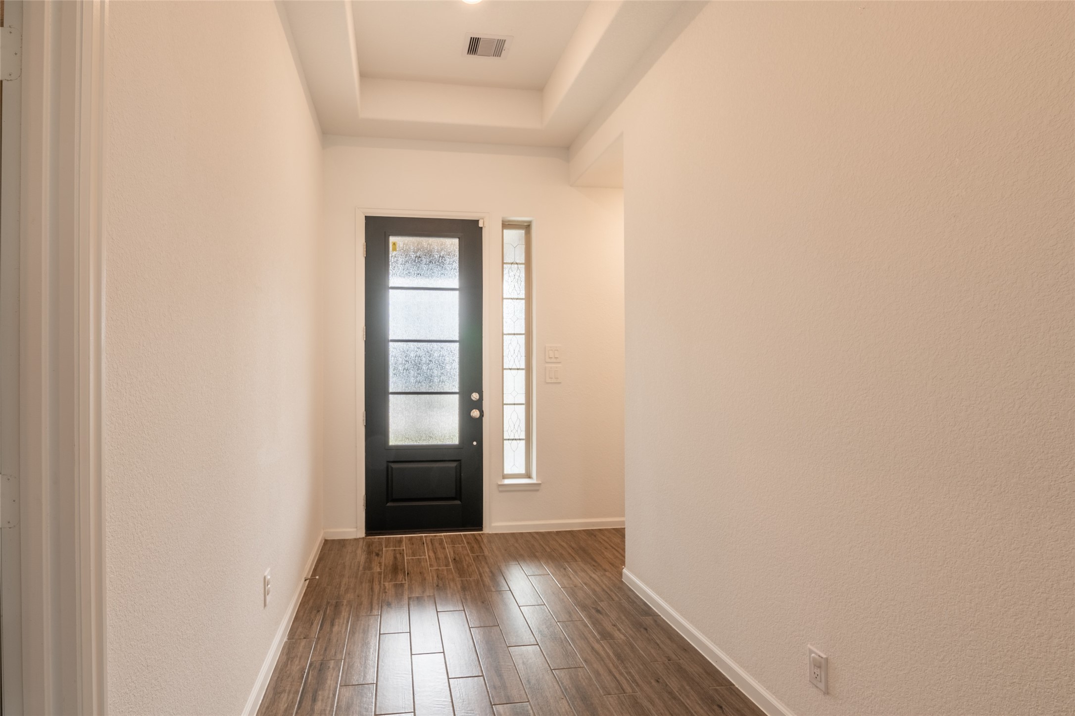 15023 Mulberry Hallow Street Conroe, TX 77302 - Photo 16 of 41 a view of an empty room with wooden floor and a window