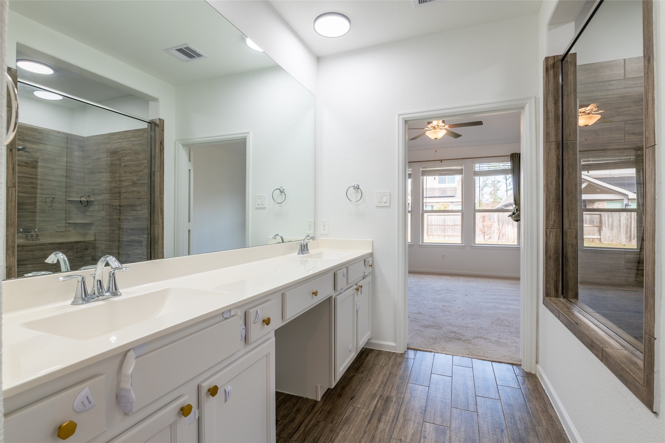 15023 Mulberry Hallow Street Conroe, TX 77302 - Photo 20 of 41 a spacious bathroom with a double vanity sink a mirror and a shower