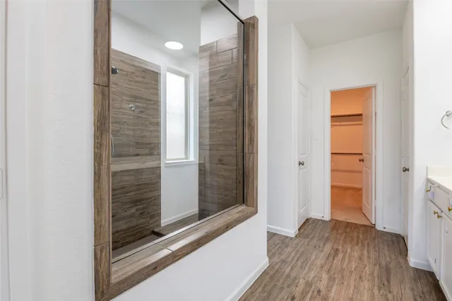a view of hallway with stairs and wooden floor