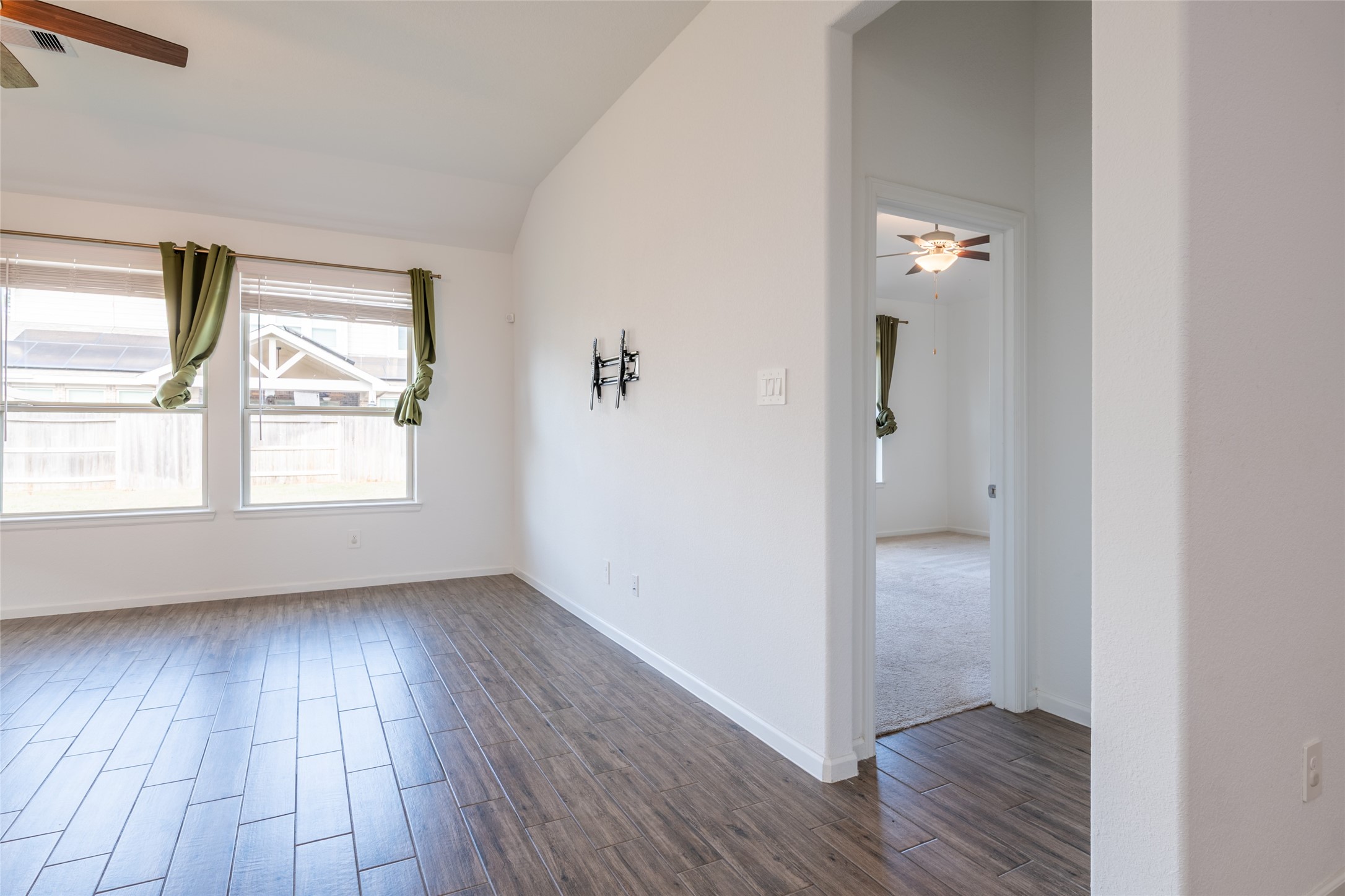 15023 Mulberry Hallow Street Conroe, TX 77302 - Photo 29 of 41 an empty room with wooden floor and windows