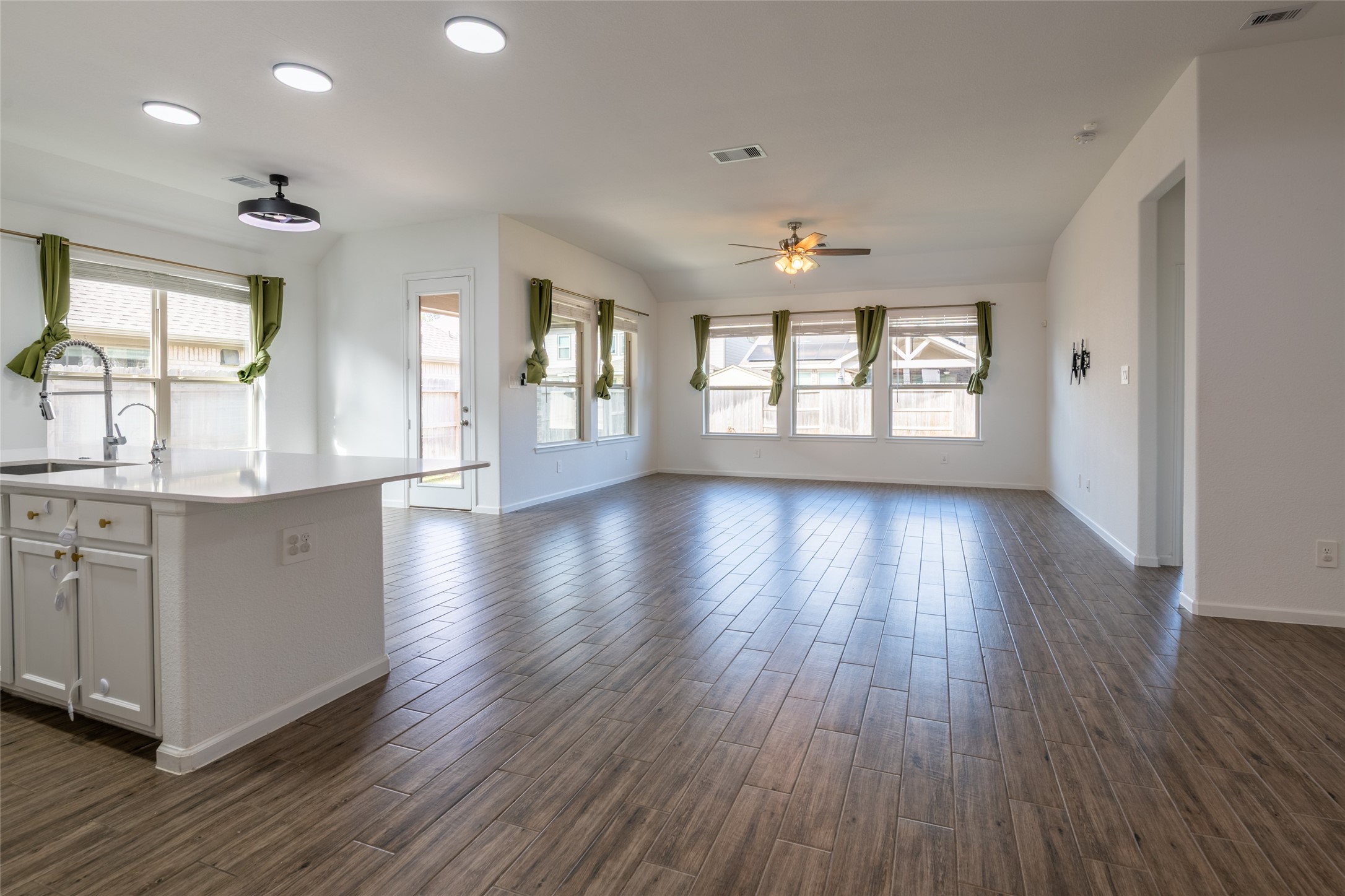 15023 Mulberry Hallow Street Conroe, TX 77302 - Photo 6 of 41 an empty room with wooden floors and windows