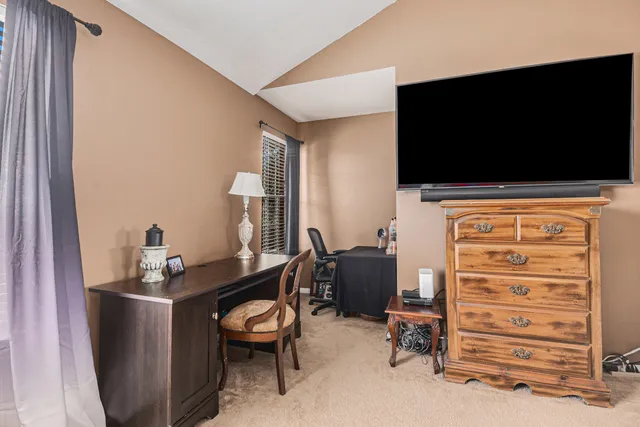 a view of a livingroom with furniture and a flat screen tv