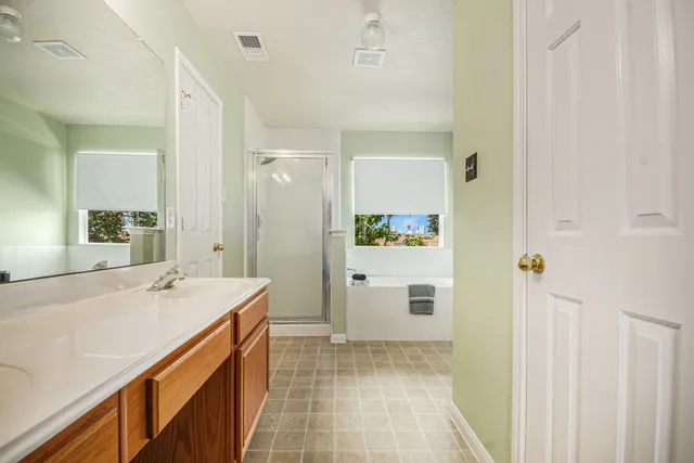 a bathroom with a sink a mirror and a shower
