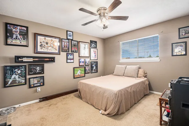 a bedroom with a bed dresser and window