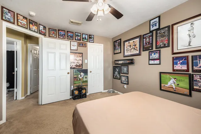 a bedroom with a bed and a chandelier