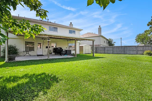 a view of a house with a yard and sitting area