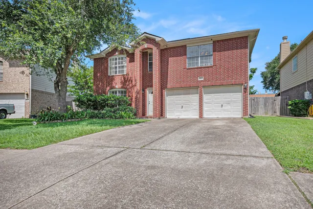 a front view of house and yard with trees