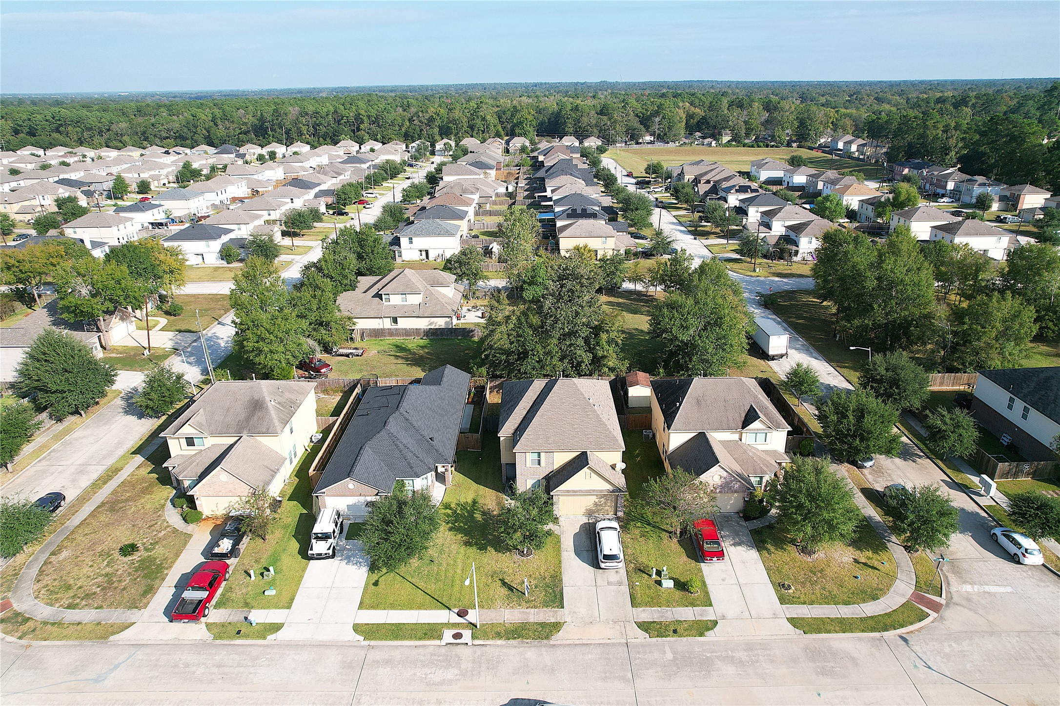 9877 Lace Flower Way Conroe, TX 77385 - Photo 41 of 43 an aerial view of residential houses with outdoor space and parking