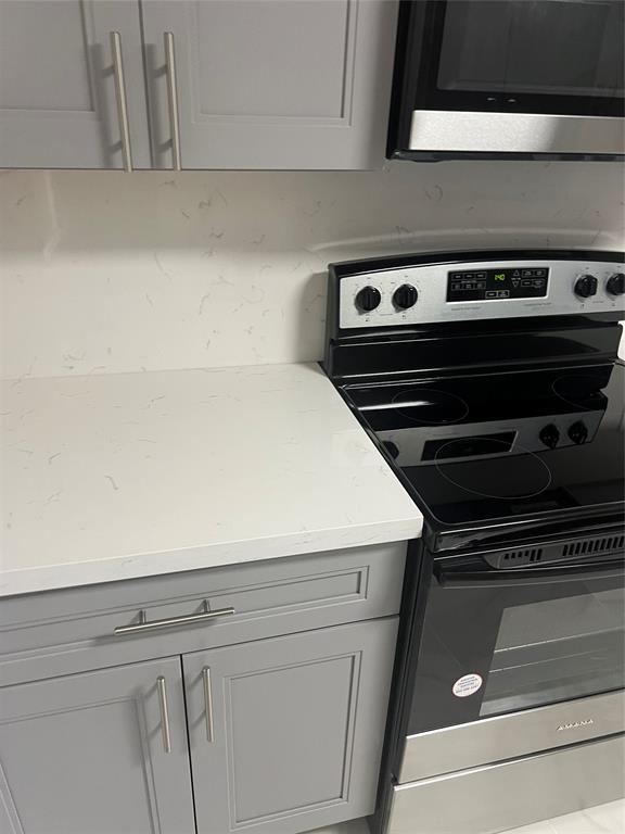 8705 Northwest 38th Drive, Unit 2A Coral Springs, FL 33065 - Photo 11 of 51 a close view of stove top oven