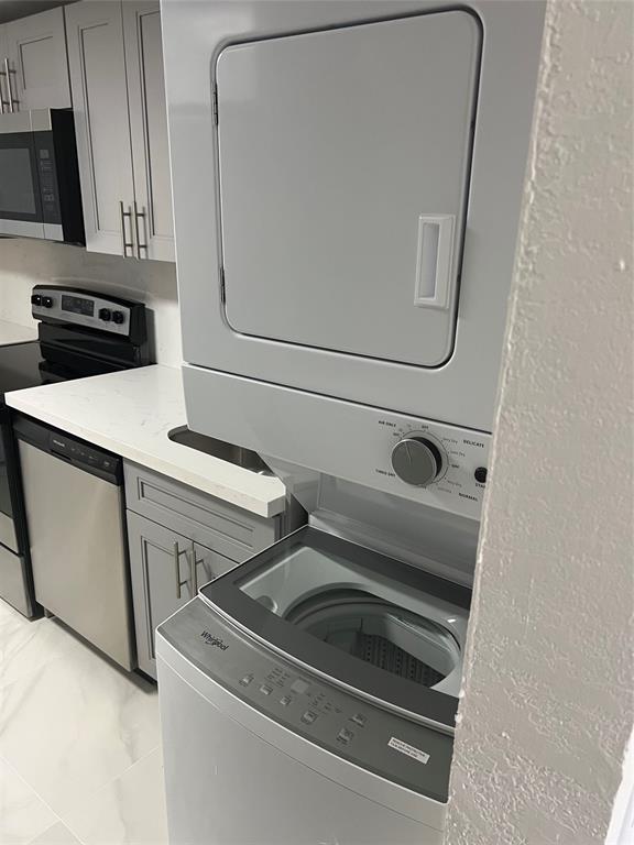 8705 Northwest 38th Drive, Unit 2A Coral Springs, FL 33065 - Photo 19 of 51 a utility room with dryer and washer
