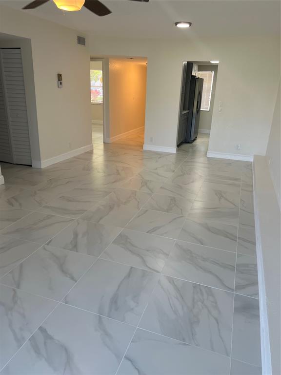 8705 Northwest 38th Drive, Unit 2A Coral Springs, FL 33065 - Photo 22 of 51 a view of an empty room with window and wooden floor
