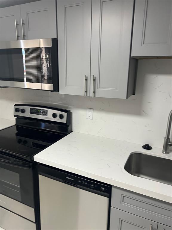 8705 Northwest 38th Drive, Unit 2A Coral Springs, FL 33065 - Photo 4 of 51 a kitchen with a sink and cabinets