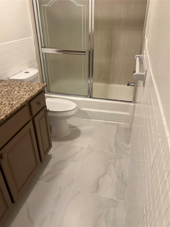 8705 Northwest 38th Drive, Unit 2A Coral Springs, FL 33065 - Photo 41 of 51 a bathroom with a granite countertop sink toilet and shower