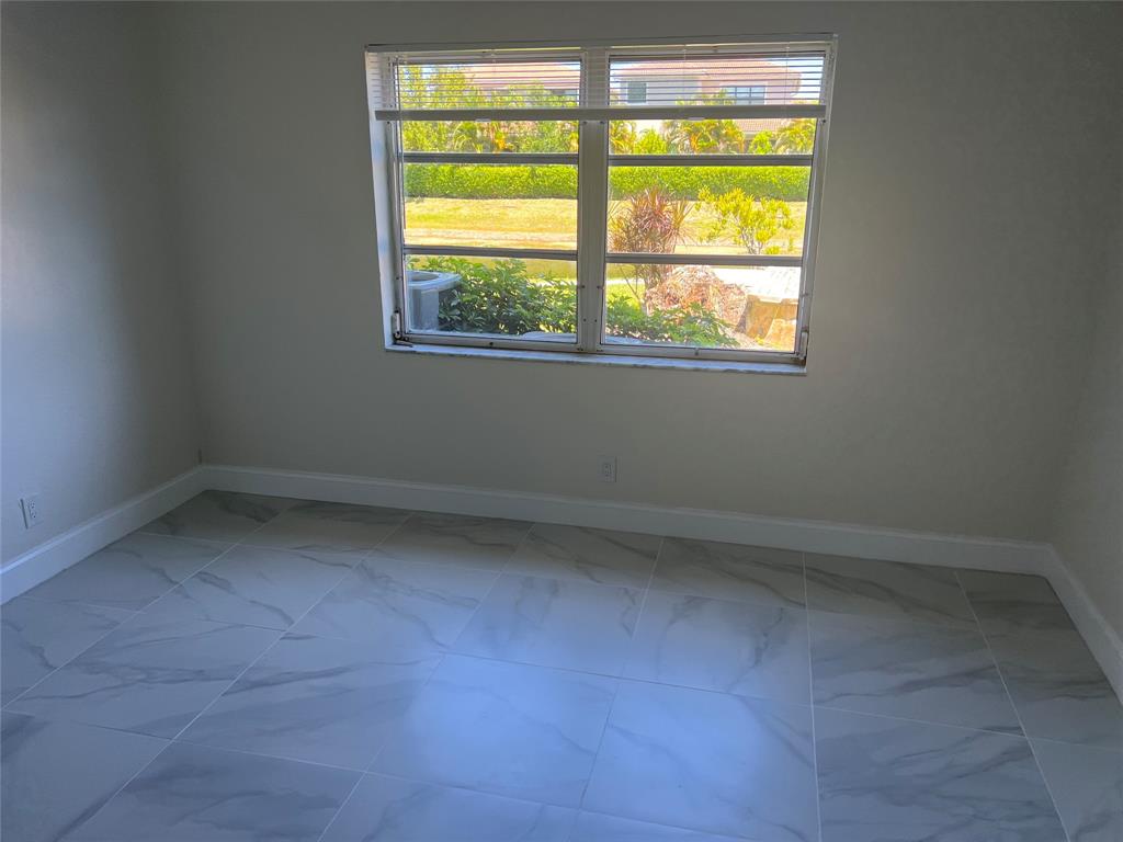 8705 Northwest 38th Drive, Unit 2A Coral Springs, FL 33065 - Photo 46 of 51 an empty room with a window