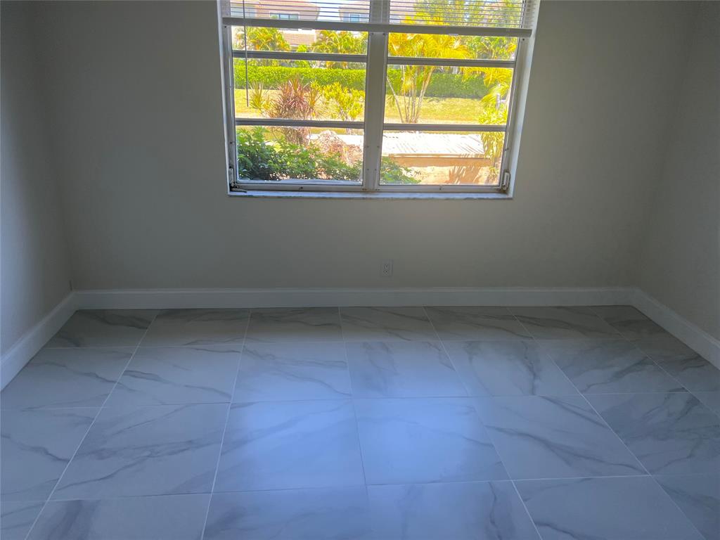 8705 Northwest 38th Drive, Unit 2A Coral Springs, FL 33065 - Photo 47 of 51 an empty room with a window