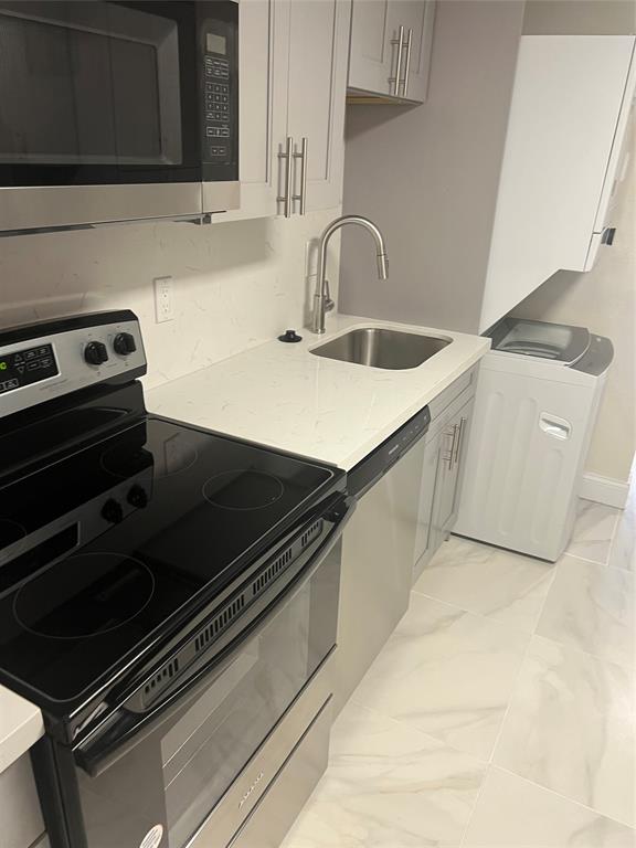 8705 Northwest 38th Drive, Unit 2A Coral Springs, FL 33065 - Photo 8 of 51 a close view of a sink and an oven