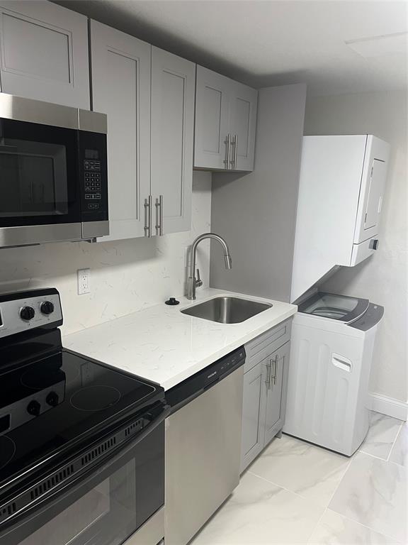 8705 Northwest 38th Drive, Unit 2A Coral Springs, FL 33065 - Photo 9 of 51 a kitchen with appliances a sink and cabinets