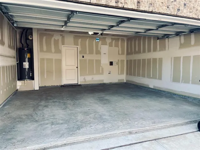 a view of swimming pool with outdoor seating and house in the background