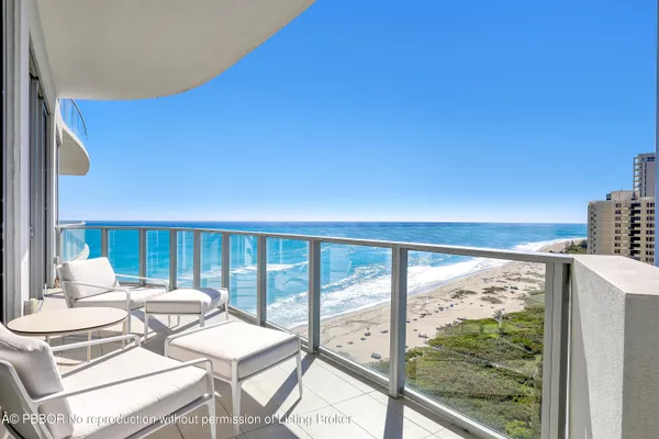 a balcony view with a large window and couch