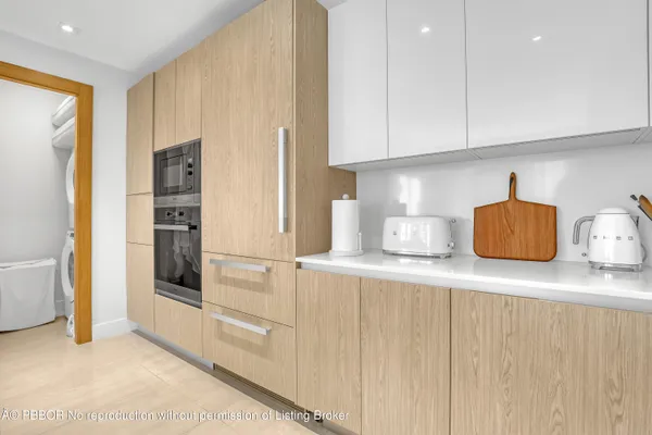 a kitchen with stainless steel appliances granite countertop a refrigerator and a stove