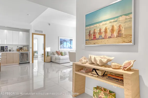 a living room with furniture and painting on the wall