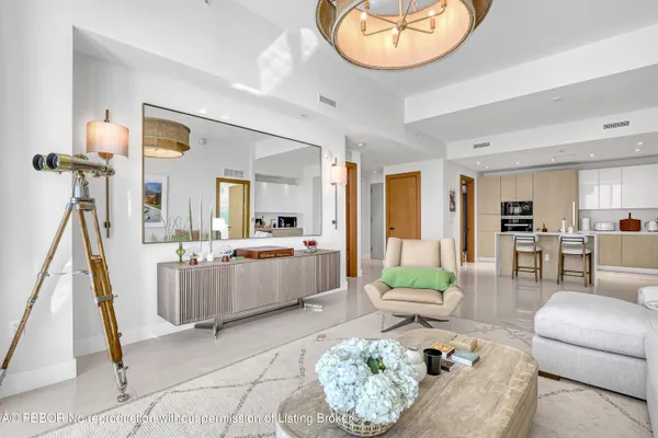 a living room with furniture and a dining table