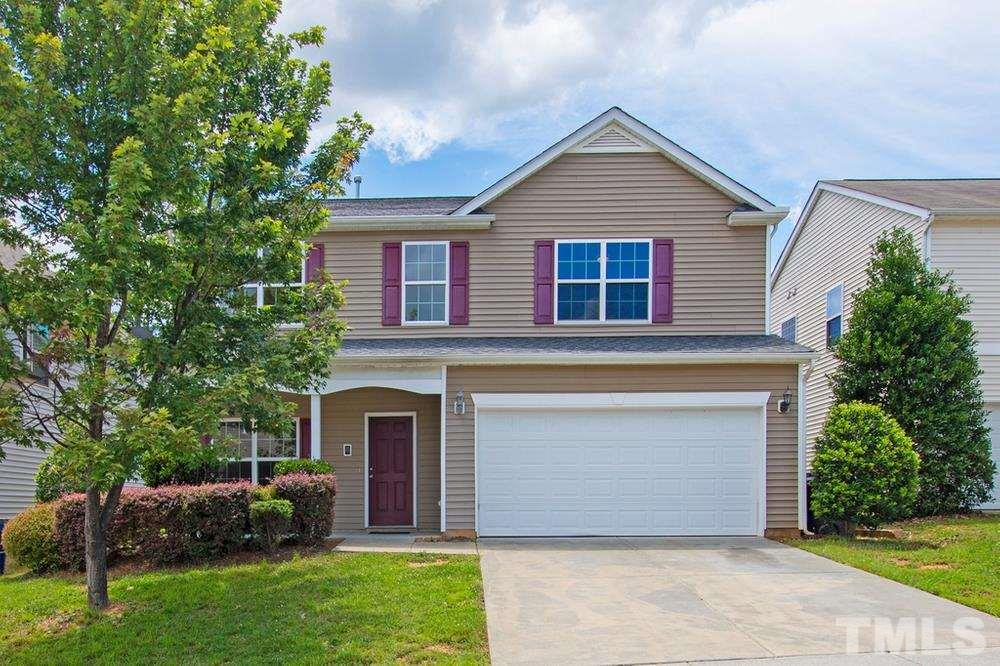 2520 Follow Me Way Raleigh, NC 27610 - Photo 1 of 30 a front view of a house with a garden and plants