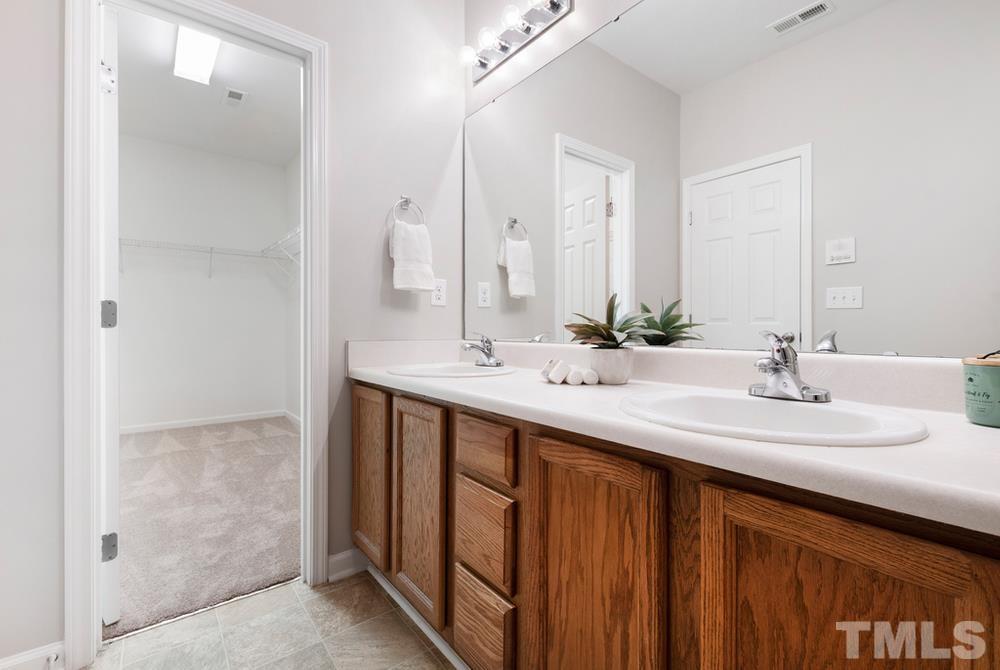 2520 Follow Me Way Raleigh, NC 27610 - Photo 13 of 30 a bathroom with double vanity sinks and a mirror