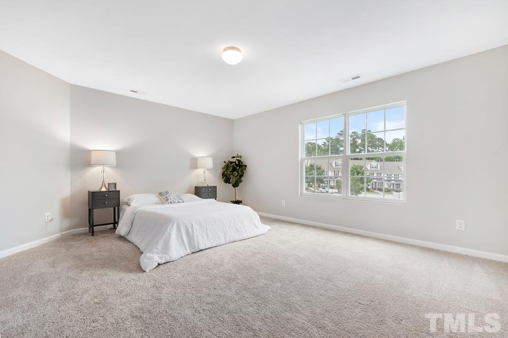 2520 Follow Me Way Raleigh, NC 27610 - Photo 17 of 30 a spacious bedroom with a bed and a window