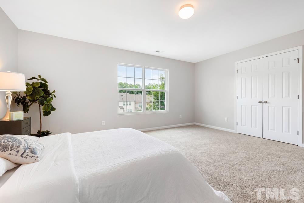2520 Follow Me Way Raleigh, NC 27610 - Photo 18 of 30 a bedroom with a bed and a potted plant