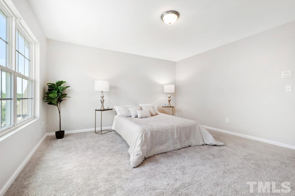 2520 Follow Me Way Raleigh, NC 27610 - Photo 20 of 30 a bed room with a bed and a potted plant