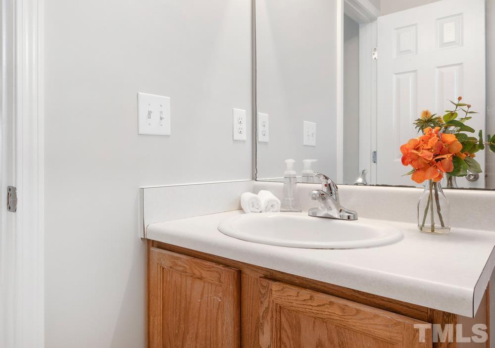 2520 Follow Me Way Raleigh, NC 27610 - Photo 24 of 30 a bathroom with a sink vanity and a mirror
