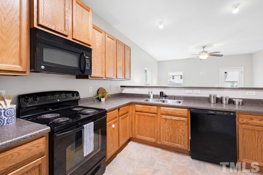 2520 Follow Me Way Raleigh, NC 27610 - Photo 6 of 30 a kitchen with a sink stove and microwave