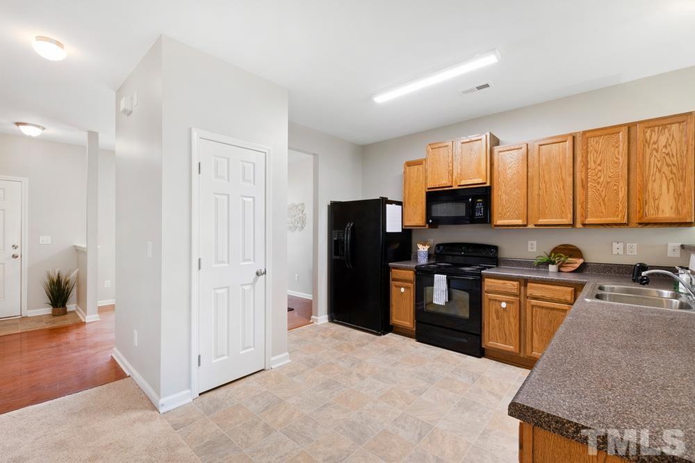 2520 Follow Me Way Raleigh, NC 27610 - Photo 8 of 30 a kitchen with stainless steel appliances granite countertop a refrigerator stove and sink
