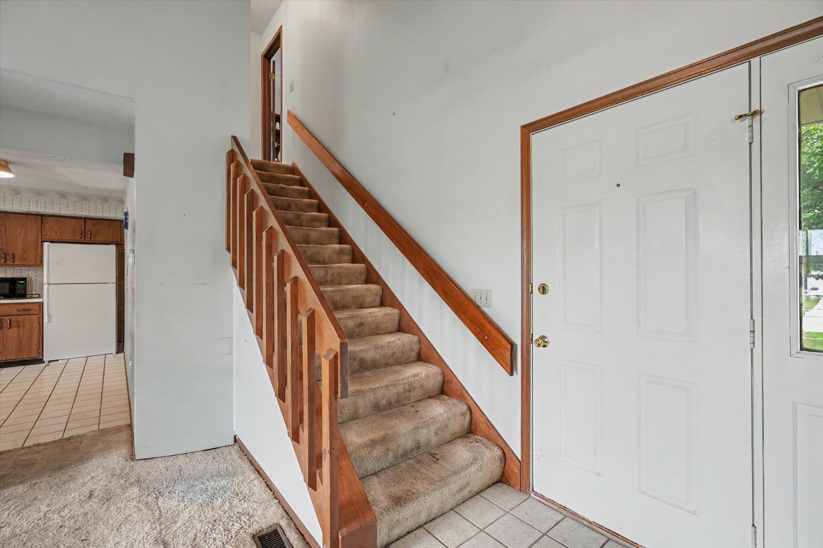 711 Higgins Road Champaign, IL 61822 - Photo 7 of 23 a view of staircase with railing and white walls