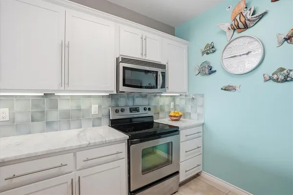 a bathroom with a granite countertop sink a toilet and a mirror