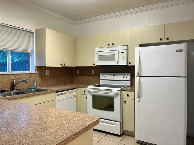 a kitchen with a sink a stove and refrigerator