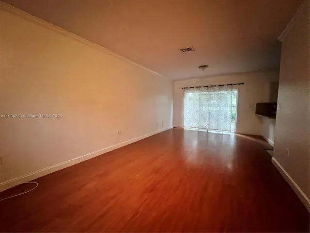 a view of wooden floor and windows in a room