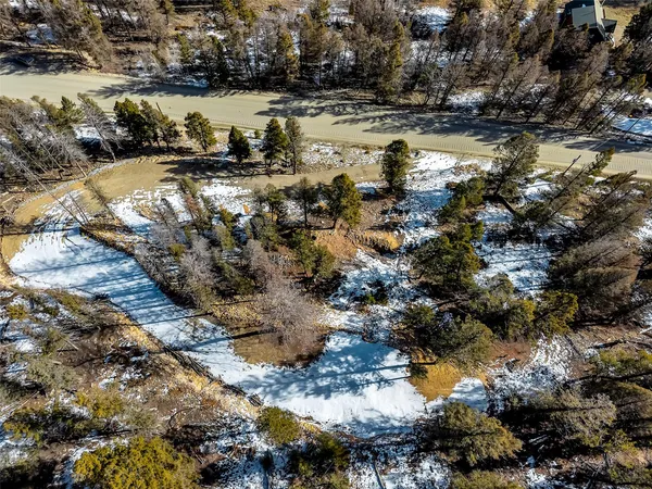 a view of a yard with snow on the road