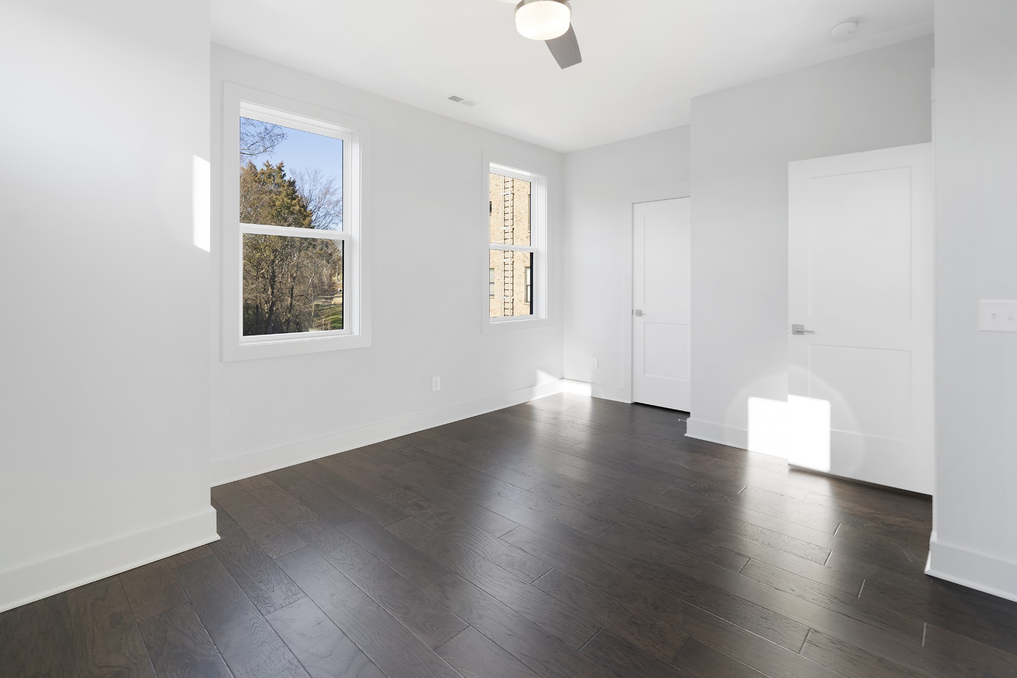 710 Inspiration Boulevard Madison, TN 37115 - Photo 20 of 43 an empty room with wooden floor and windows