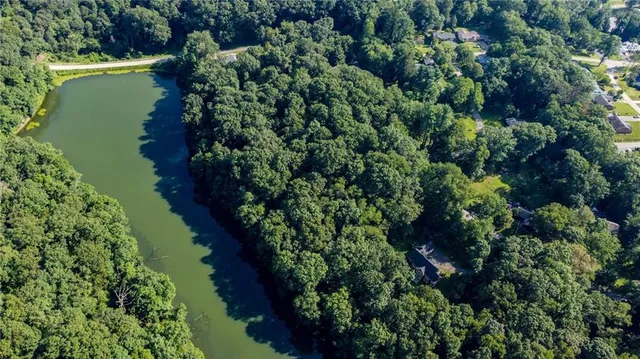 an aerial view of a house with a yard and lake view