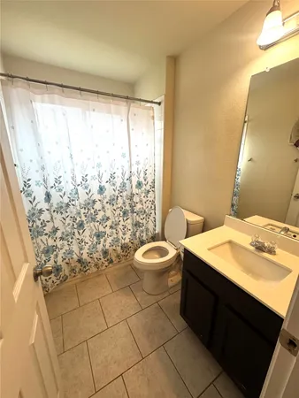 a bathroom with a sink a toilet and vanity