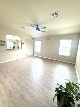 a large kitchen with stainless steel appliances a stove a sink dishwasher and a refrigerator with wooden cabinets