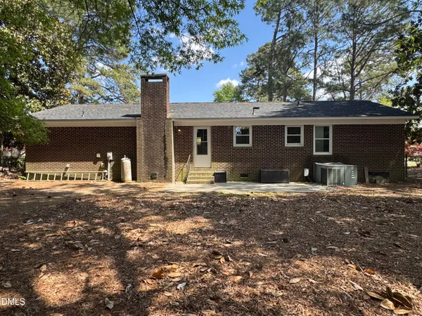 a front view of a house with yard patio and fire pit