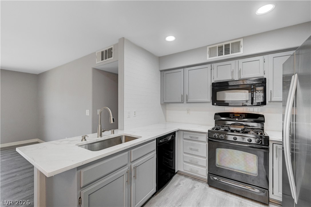 3425 East Russell Road, Unit 223 Las Vegas, NV 89120 - Photo 6 of 47 Culinary delights await in this sleek kitchen featuring a gas range and ample counter space.