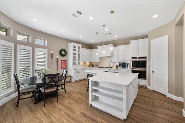 a large kitchen with stainless steel appliances granite countertop a stove and a sink